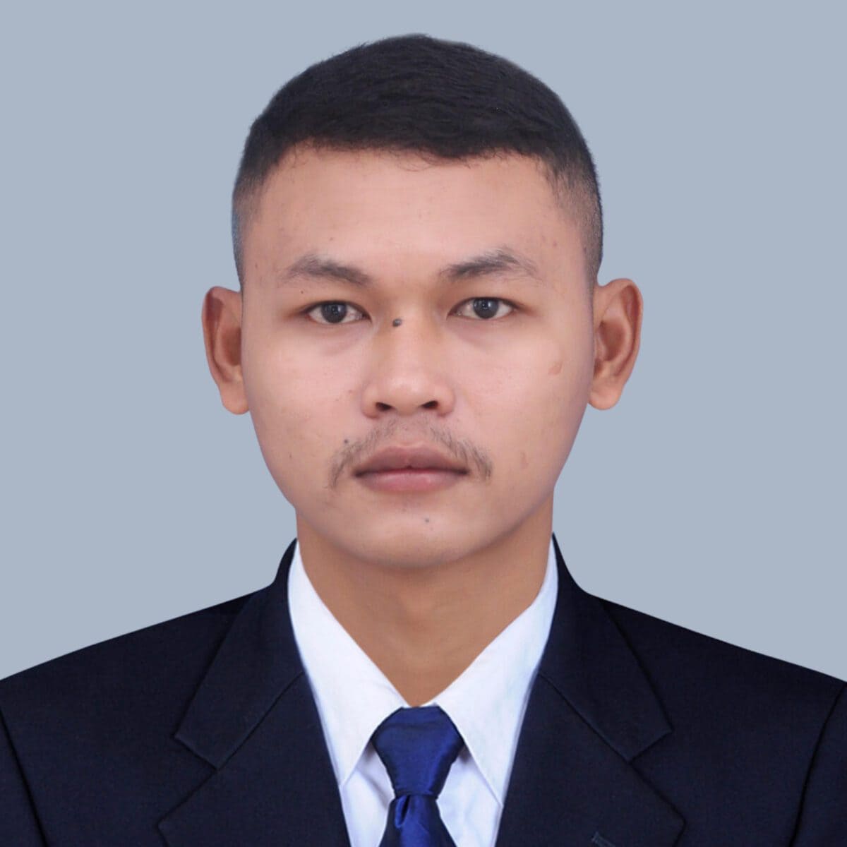 TDSO Professional portrait of a young man in formal attire, representing teacher development and support.