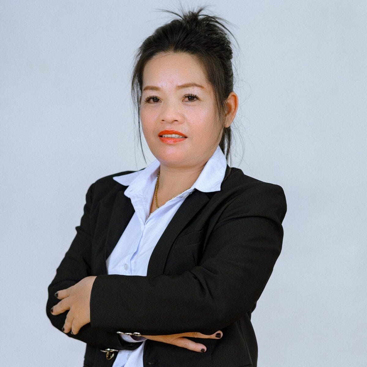TDSO Professional woman in business attire with crossed arms, promoting teacher development and support.