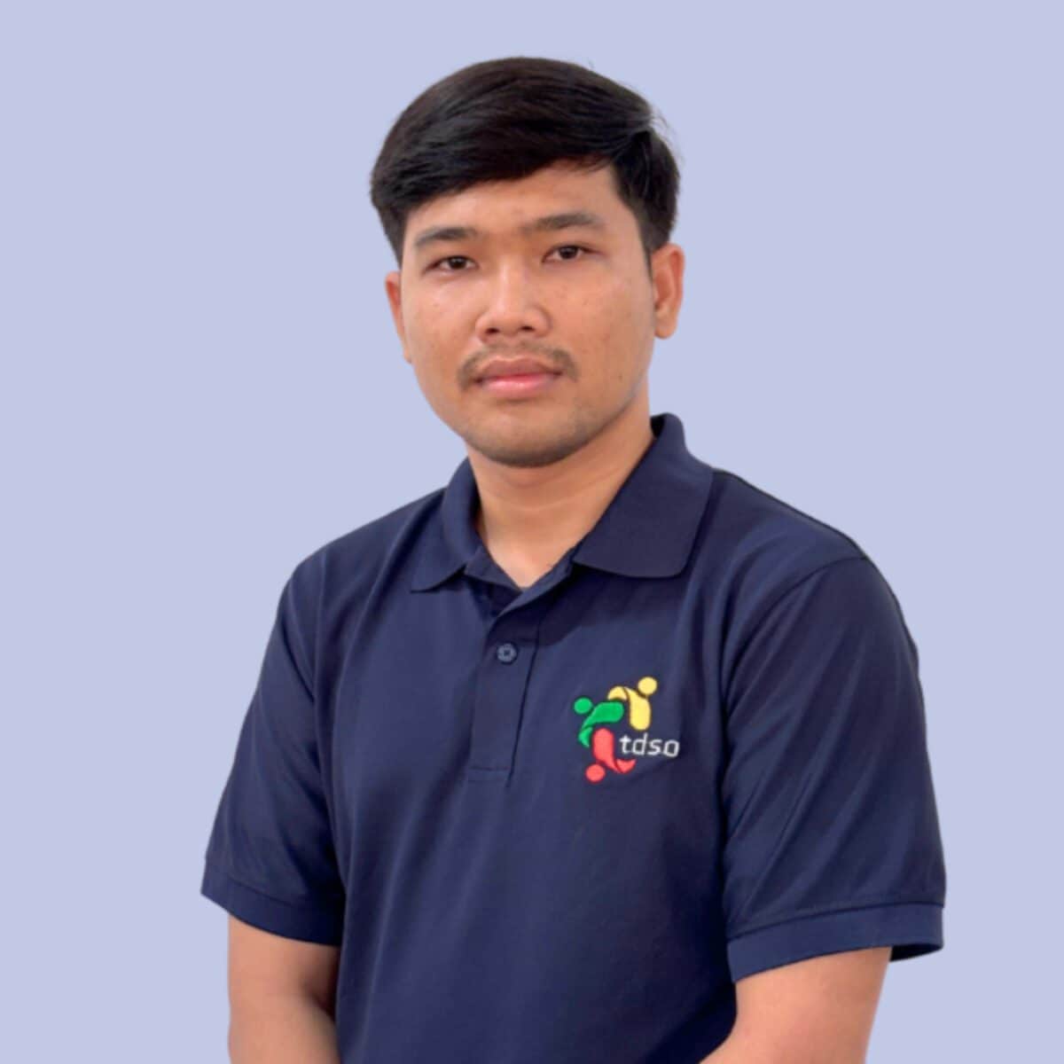 TDSO Teacher wearing TDSO organisation polo shirt, promoting teacher development and support initiatives.