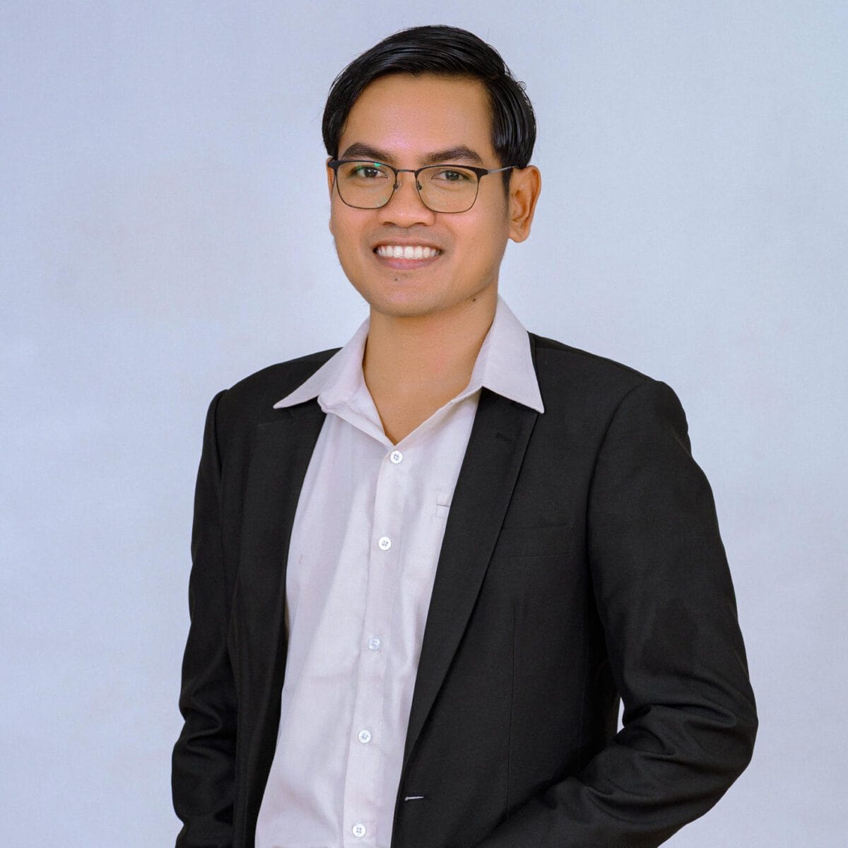 TDSO Professional male teacher in formal attire smiling, promoting education development.