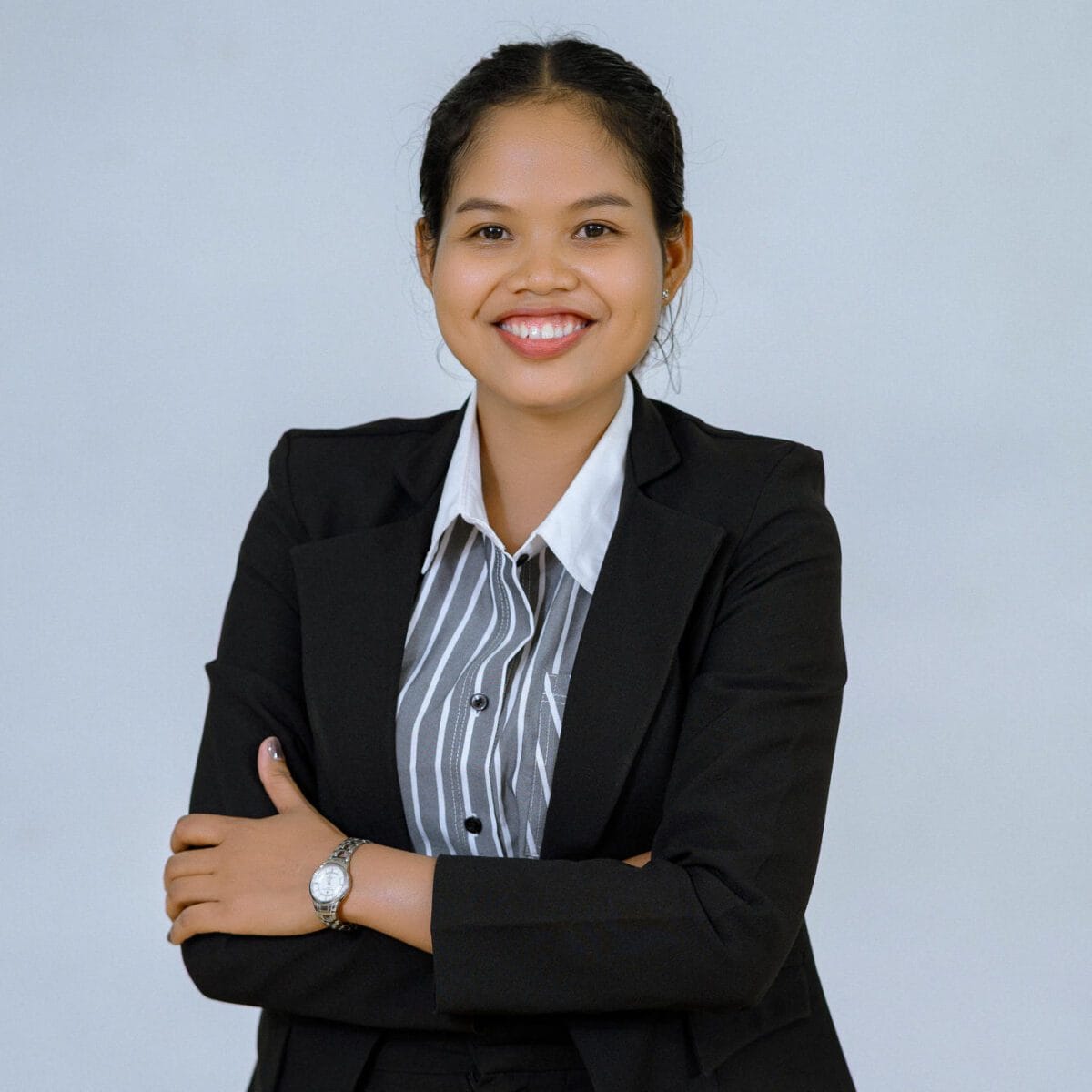 TDSO Professional woman in business suit smiling, representing teacher development support.
