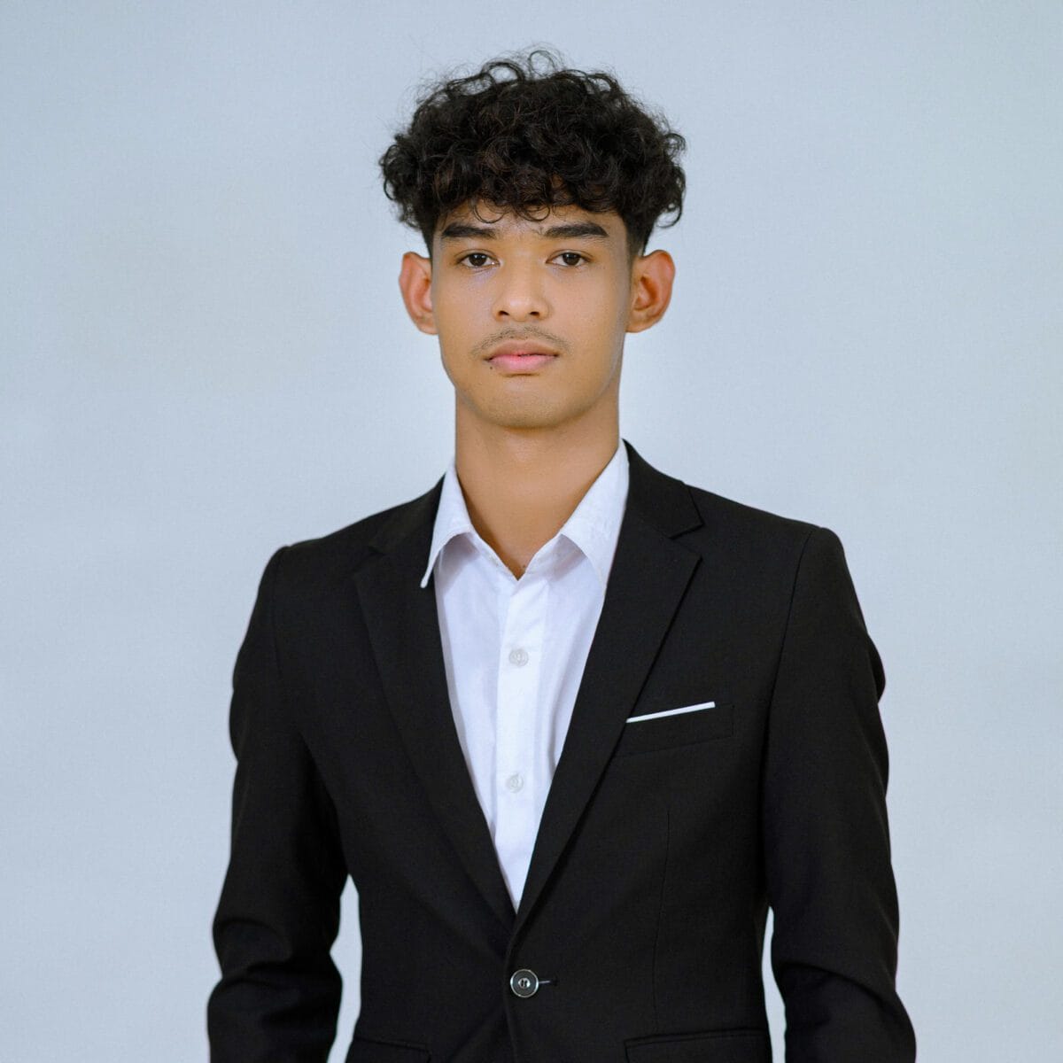 TDSO Young man in formal suit representing teacher development and support initiatives.