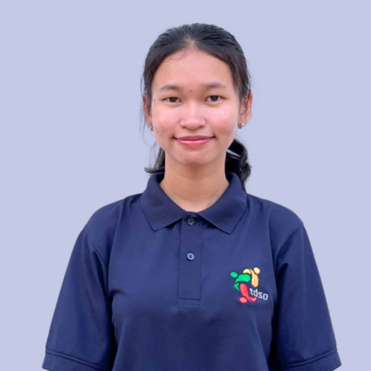 TDSO Young girl in TDSO uniform smiling, promoting teacher development and support.