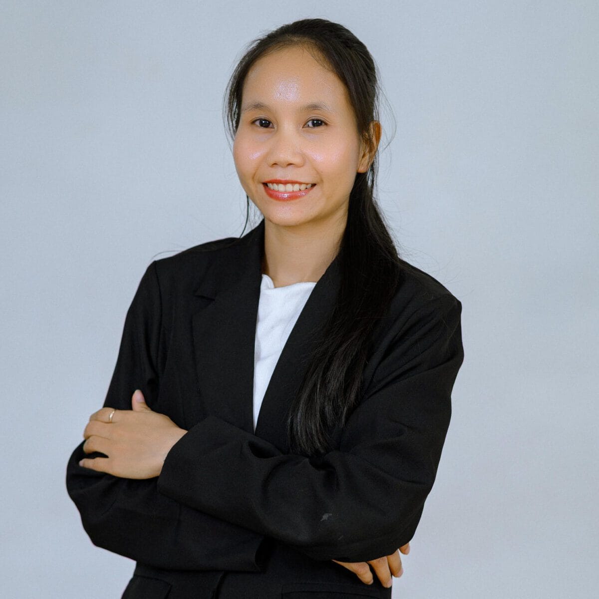 TDSO Professional woman in business attire smiling, representing teacher development support.