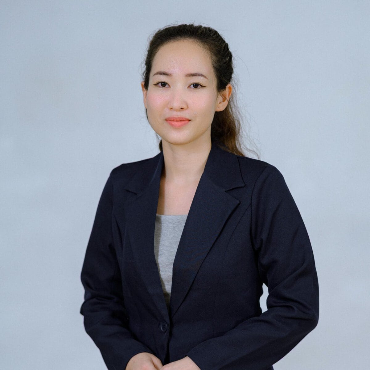 TDSO Female educator in professional attire, representing teacher development and support initiatives.