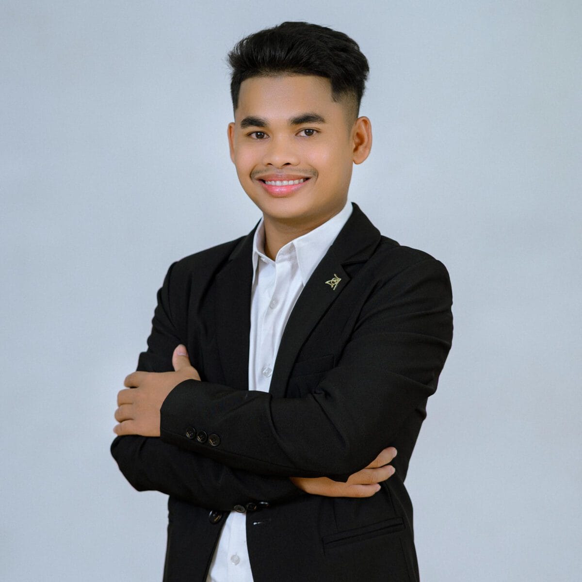 TDSO Young professional man in formal attire smiling confidently, representing education support.